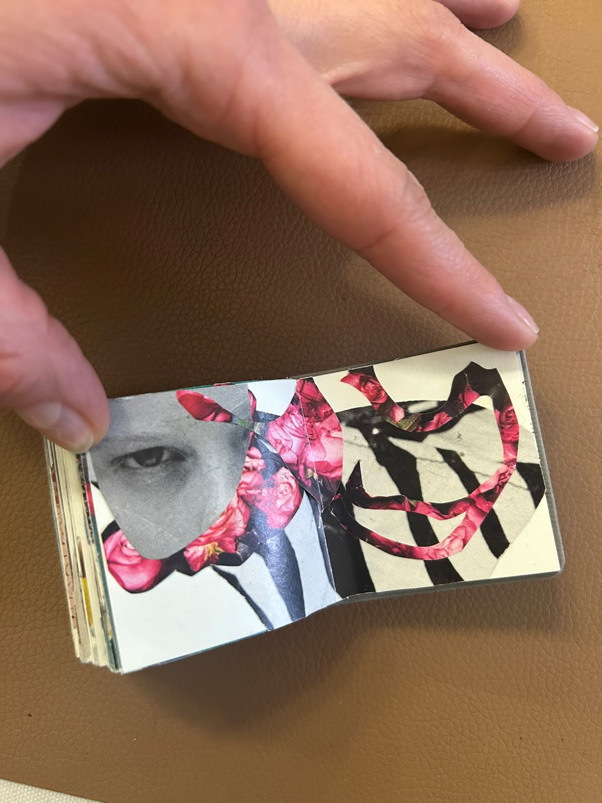 Handmade collage book opened to a rose-toned portrait and cut-paper composition