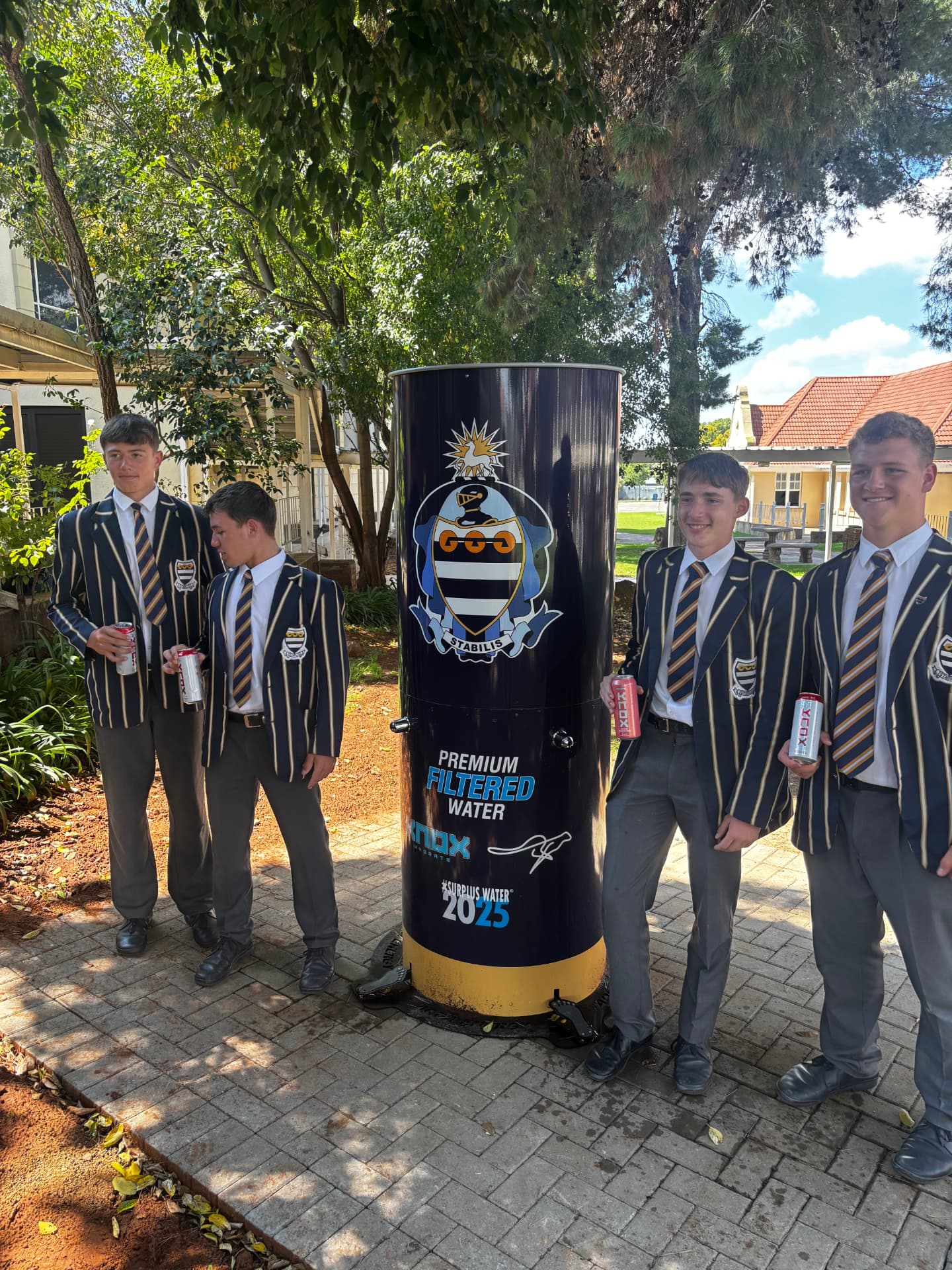Learners alongside a school-branded hydration station