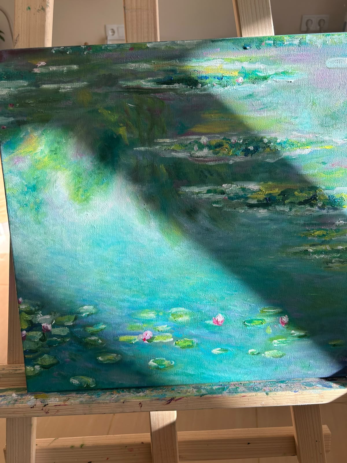 Painting of a luminous blue-green pond with water lilies