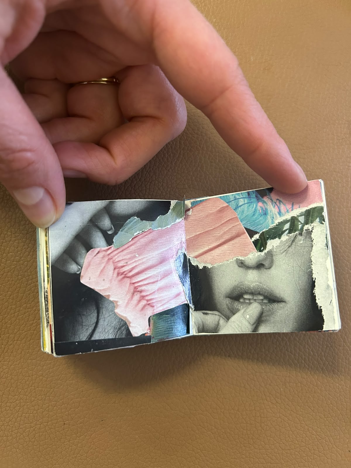 Handmade collage book opened to overlapping portraits and textured pink paper